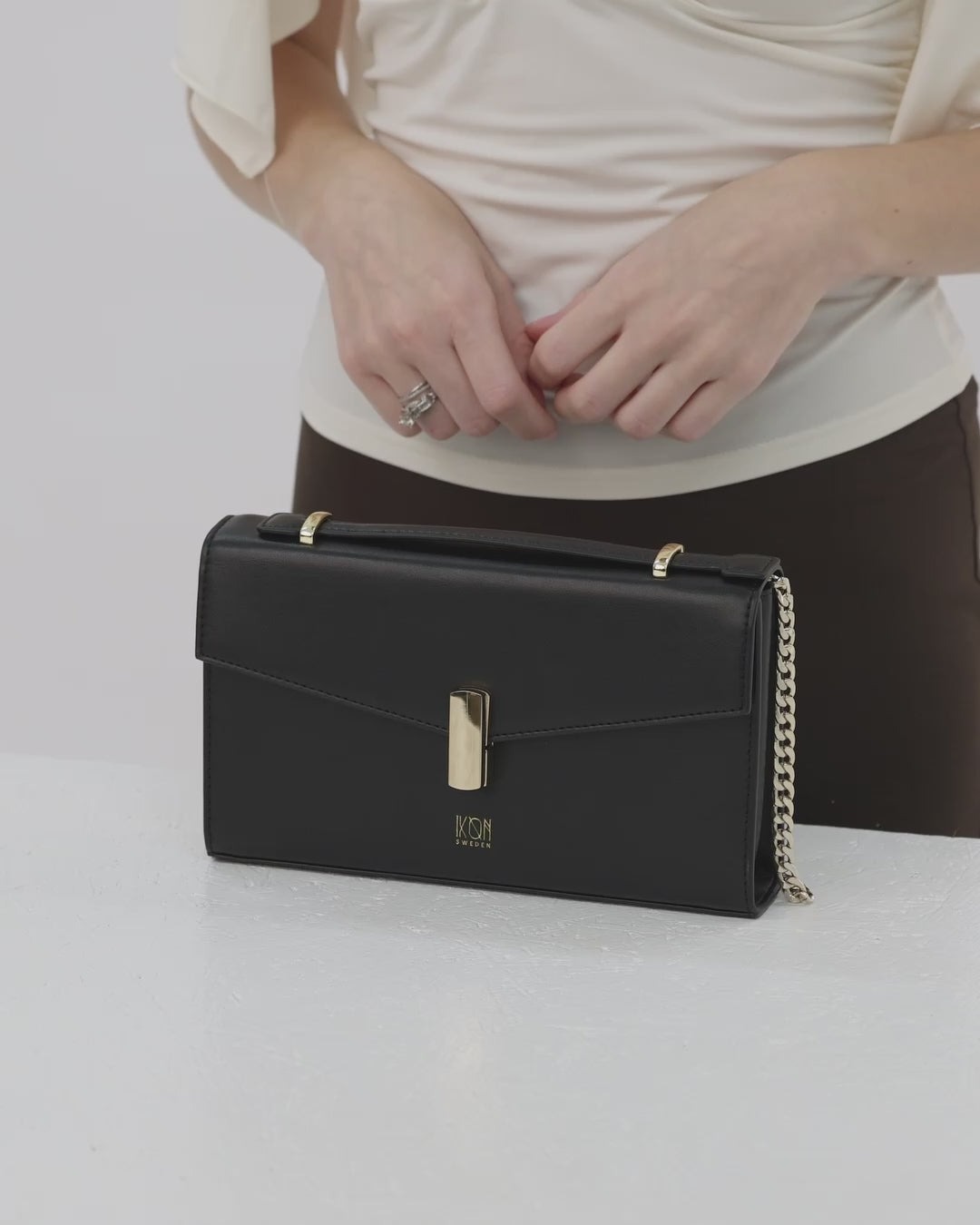 Black handbag with gold chain 